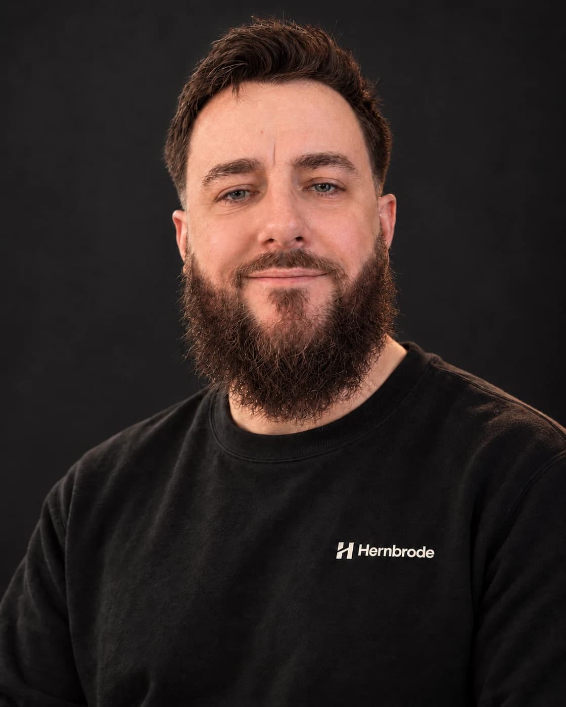 Editorial portrait of Raymond Hernbrode in a black Hernbrode sweatshirt